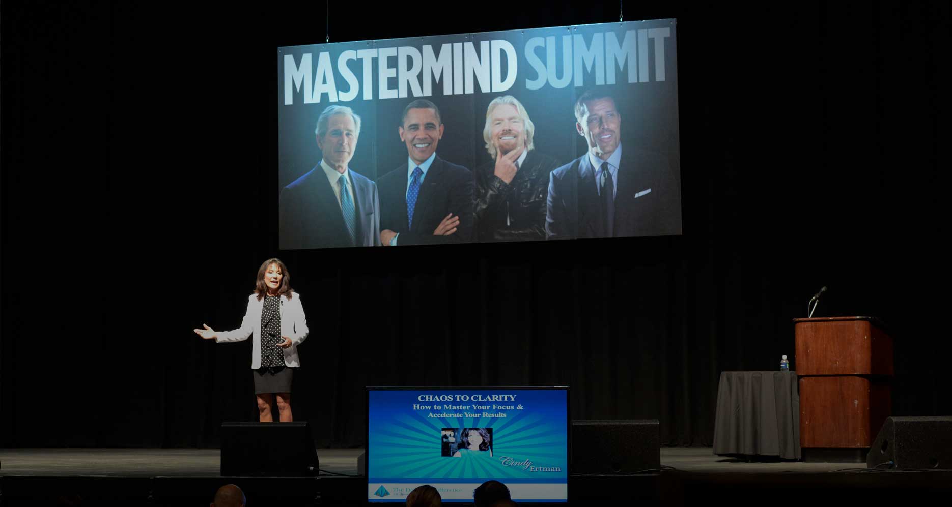Cindy Ertman presenting about chaos and clarity on stage at a Mastermind Summit